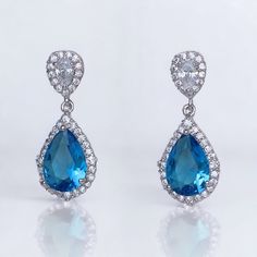 Layla turquoise blue crystal earrings have the most beautiful sparkle due to the halo of tiny crystals surrounding both the earpost and the teardrop. We have used a clear crystal earpost which is also available as a clip on, to create a versatile and very pretty earring.    Measurement: L-1" (2.5cm) Set in non tarnish rhodium and are nickel, lead and cadmium free. ★Shopping for your bridal party? Contact us for special pricing. ★Note: We also ship this item from Australia to Australia , NZ & Asia UK & EU. ¸.**'.**'.**'.**'.**'.**'.**' Please read our shop policies @ http://www.etsy.com/shop/JamJewels1/policy before committing to your purchase. Thank you Find us on Facebook http://www.facebook.com/jamjewels2010 Find us on Pinterest http://pinterest.com/jamjewels1 Blue Bridal Earrings, Blue Crystal Earrings, Turquoise Crystal, Blue Bridal, Bleu Turquoise, Wedding Jewelry Earrings, Pretty Earrings, Something Blue, Blue Crystals