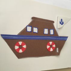 a paper cut out of a brown boat