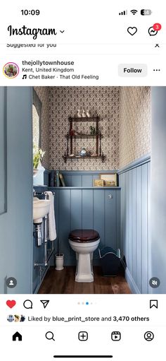 a bathroom with blue walls and wood flooring is featured in the instagram page