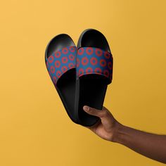 Unveiling the ultimate footwear for Phish enthusiasts - our slick black slides flaunting the iconic Fishman donut pattern. Experience the perfect blend of comfort and style as you dive feet first into the pulsating world of jamband culture. Our slides seamlessly mesh the vibrant allure of the Fishman donut pattern with a sophisticated black backdrop, crafting a footwear masterpiece that resonates with both die-hard Phish fans and the uninitiated. The mesmerizing pattern is more than a design; it's a symbol of music, unity, and countless unforgettable concert nights. Crafted with precision, these slides prioritize comfort, ensuring your feet remain cushioned, whether you're grooving at a festival or chilling on a laid-back afternoon. The durable sole promises longevity, so you can flaunt yo Modern Black Slip-on Flip Flops, Modern Black Slip-on Slides, Donut Pattern, Mens Shoes Sandals, Black Backdrop, Black Slides, Black Backdrops, Phish, Concert Tees