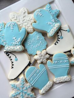 decorated cookies in the shape of mittens and snowflakes