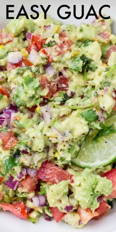 a white bowl filled with guacamole, tomatoes, onions and cilantro