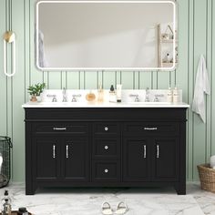 a bathroom vanity with two sinks and a large mirror above it, against a green striped wall