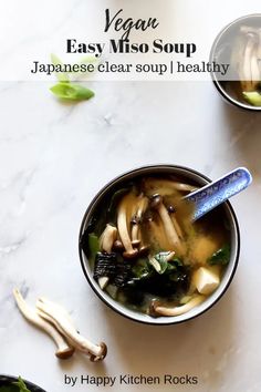 two bowls filled with soup sitting on top of a white counter next to green vegetables