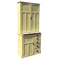 an old fashioned white cabinet with drawers on it's front and side doors open