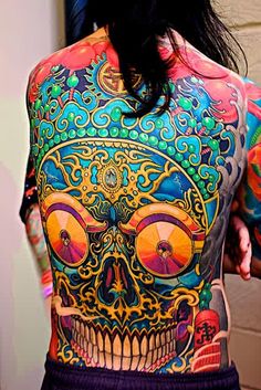 a woman with colorful tattoos on her back