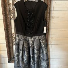 Super Cute Party Dress. Top Is Black With Very Detailed Beading. Bottom Is Grey With Black And Silver Rose Pattern. Back Zip! Length Falls Right Above The Knee. Brand New With Tags! #Christmasdress #Holidaydress #Newyearspartydress Gray Sequin Dress For Formal Occasions, Gray Sequin Evening Dress, Formal Gray Sequin Dress, Gray Embellished Party Dress, Gray Knee-length Party Dress, Gray Evening Dress For Holiday, Elegant Gray Dress For Night Out, Gray Embellished Sleeveless Dress, Elegant Gray Embellished Dress