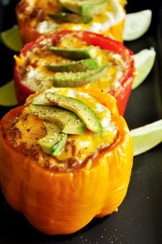 four stuffed peppers with different toppings on them