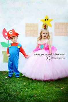 two children dressed up in mario and luigi costume standing next to each other on grass