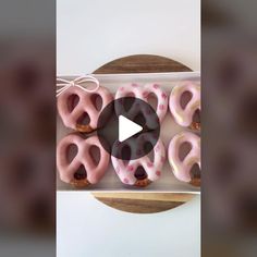 donuts with pink frosting and sprinkles in a box