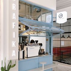 a blue and white coffee shop with the word craftka on it