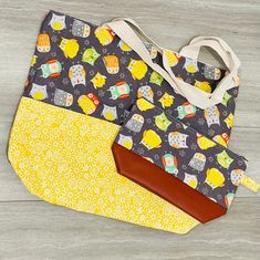 This large tote bag with matching zippered cosmetic bag is the perfect gift for any occasion! Makes a wonderful diaper bag, beach bag or weekender bag! Tote bag: - measures approximately 18.5 inches wide by 15 inches long with a 5 inch wide bottom - two identical pockets on the front - metal snap closure - heavy-duty canvas lining - cotton design - designed to hold up to 25 pounds Zipper cosmetic bag: - made of cotton and faux leather - measures approximately 10.5 inches long by 7 inches high with a 3 inch wide bottom Please message with any questions or for custom orders (including sports teams) or bulk orders :) Yellow Cosmetic Bag With Removable Pouch For Everyday Use, Everyday Tote Cosmetic Bag With Zipper, Large Capacity Tote Pouch For Gifts, Zipper Pouch Tote Cosmetic Bag, Zipper Tote Cosmetic Bag As Gift, Gift Cosmetic Tote Bag With Zipper, Large Capacity Tote Cosmetic Bag Gift, Daily Use Cosmetic Tote With Zipper, Tote Cosmetic Bag With Zipper