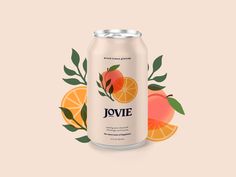 a can of juice with oranges and leaves around it on a pink background that says jovie