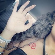 a woman's hand with a tattoo on her left shoulder and the number 35 tattooed on her right arm