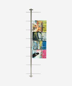 a tall metal pole with multiple pictures on it