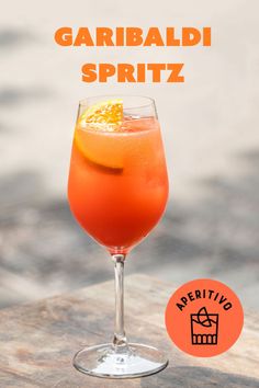 an orange drink in a wine glass with the words garbadi spiritz next to it