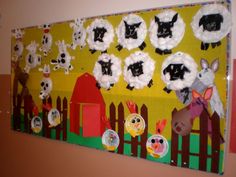 a bulletin board with sheep and farm animals on it's sides, hanging from the wall