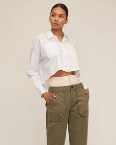 Honoring our brand's heritage, we updated the classic utilitarian cargo pant with feminine details. A high waist corset waistband is paired with vintage washed cargo details to give the Ada its modern feel. Pair the Ada with a classic white shirt or a tank for a ready to go everyday anywhere look. High corset waist Front fly zipper and Horn button closure Shell button closure on attached corset Front cargo pockets, back patch pockets with flap Belt loops Tapered Leg Front lace up detail at the h Cropped Cotton Bottoms With Pockets, Cropped Workwear Bottoms With Pockets, Cropped Bottoms With Pockets For Work, Cropped Cotton Pants With Pockets, Cropped Cotton Bottoms With Belt Loops, Fitted Cropped Bottoms With Pockets, Chic Cropped Bottoms With Pockets, Cropped Bottoms With Belt Loops For Workwear, Cropped Utility Bottoms For Fall