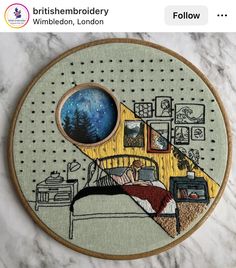 an embroidery project with a bedroom scene in the middle and trees on the other side