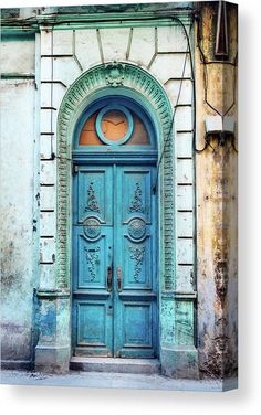 an old building with a large blue door