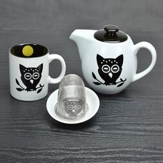 two coffee cups and a teapot with owls on them