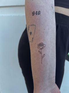 a person with a tattoo on their arm that says 40 and has a rose in front of it