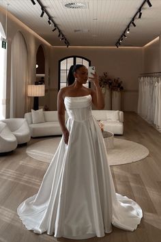 Bride taking selfie in mirror at a bridal shop wearing a white, strapless wedding dress with a scoop neckline, a boned bodice, and an a-line skirt. All in a satin mikado fabric. Wedding Dress Backless, Dress Backless, Wedding Dresses Strapless, Satin Wedding Dress, Custom Bridal, Satin Wedding, Dresses Strapless, Made With Love, Side Pocket