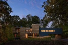 a modern house in the woods at dusk