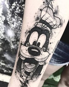 a person with a mickey mouse tattoo on their arm