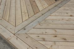 a skateboarder is on the edge of a wooden deck that's being built