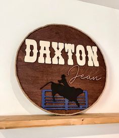 a wooden sign that reads,'saxon dean'on the side of a shelf