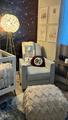 a baby's room decorated in white and blue with stars on the wall behind it