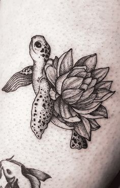 a black and white photo of a turtle with flowers on it's back leg