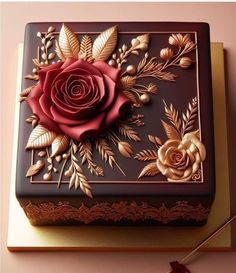 a chocolate box decorated with flowers and leaves