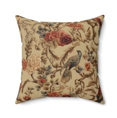 a decorative pillow with flowers and birds on it