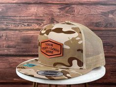 "We proudly launch our hats with genuine leather patch. - PRODUCT DETAILS -----  - Hats are YUPONG 6006 style 5 panel. - The leather patches are crafted from 100% genuine, top-quality leather made in the USA - Adjustable Snapback - One Size Fits All. - Multicam is 60/39/1 cotton/polyester/PU spandex - Structured, five-panel, high-profile - Flat bill. - The leather patches on all hats are bonded, not stitched. Our reliable and robust leather bonding technique has been employed for numerous years. - Your logo must be in a black and white JPG format. Ensure that the text and images are in black, while the background should be white. - Explore our diverse range of shapes and fonts! No logo? No worries! We can engrave your custom text using the fonts showcased in our gallery. Additionally, enjo Trucker Style Six-panel Baseball Cap With Leather Patch, Leather Six-panel Trucker Hat With Leather Patch, Trucker Hat With Leather Patch, Six-panel, Cotton Six-panel Trucker Hat With Logo Patch, Five Panel Hat, 5-panel Trucker Hat With Logo Patch For Camping, Leather Patch Hat, Logo Hat, Five Panel