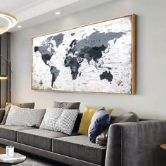 a living room filled with furniture and a large map hanging on the wall above it