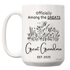 a white coffee mug with the words, officially among the greats and an image of flowers