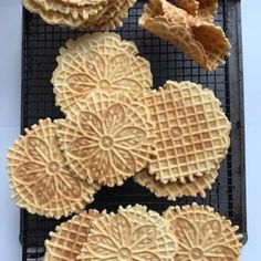 several waffles on a cooling rack with some dried fruit in the foreground