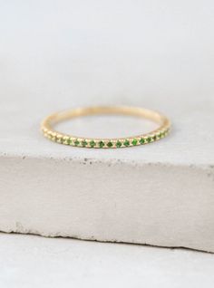 Eternity Ring - Gold + Emerald – The Faint Hearted Gold Emerald Half Eternity Jewelry, Gold Jewelry For May Birthstone With Half Eternity, Gold Emerald Half Eternity Ring, Gold Half Eternity Jewelry For May Birthstone, Gold Jewelry With Half Eternity For May Birthstone, Gold Emerald Ring With Half Eternity Design, Gold Emerald Ring With Pave Setting As Gift, Gold Emerald Rings With Pave Setting, Gold Emerald Ring With Pave Setting