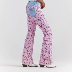 The Wrangler X Barbie Retro High Rise Trouser Jean Takes Pattern Play To A More Adventurous Place. Featuring An All-Over Pattern Of Western Riding Icons, Playful Details, And Plenty Of Pink, This Pair Offers Contrasting Pockets, A 10-Inch High Rise, And A Contoured Waist. It's A Reinterpreted Classic With Limitless Potential, Like The Women Who Wear Them. Fit: Regular Rise: High Front Rise: 10 1/4" Leg: Trouser Leg Opening: 21 3/4" Front Closure: Zipper And Button Trendy Denim Bottoms For Rodeo, Western Style Mid-rise Cotton Bottoms, Western Style Straight Leg Jeans For Spring, Casual Mid-rise Festival Jeans, Casual Mid-rise Jeans For Festival, Western Style Fitted Jeans For Spring, Spring Western Fitted Jeans, Casual Mid-rise Bottoms For Festival, Fitted Casual Jeans For Festivals