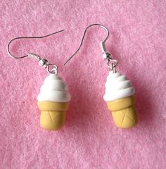 small cupcake earrings with white frosting on pink felt backing, dangling from silver earwires