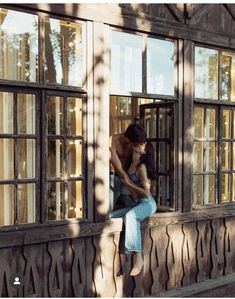 a man and woman are sitting on the window sill