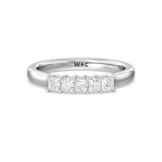 a white gold ring with three princess cut diamonds