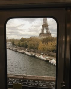 the eiffel tower is seen through an open window in this view from inside a train