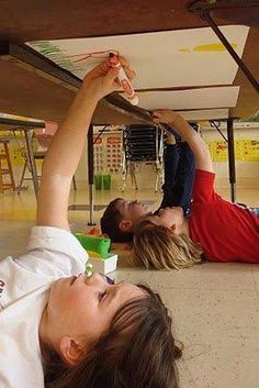 two children laying on the floor playing with toys