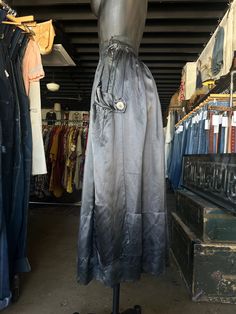 Antique Silk Charcoal Black Full Length Skirt. Charcoal gray/black in color. Brand is unknown. Skirt is made from silk fabric. Full length skirt with a flowy fit. Side hook and eye closure with snaps down the side. Super soft with a lightweight feel. Oversized button accents on sides. Condition overall is good/fair with some flaws that include; there are pinholes along front and couple on back of skirt. Small tear at bottom hem. Please see all photos for details.  Refer to measurements below to ensure a proper fit (modeled on a size small mannequin) fits true to size 12.5" across waist (25") 37" in total length Evening Full Skirt With Elastic Waistband, Evening Full Skirt Bottoms With Elastic Waistband, Silk Lined Long Skirt, Silk Full Skirt With Gathered Detail, Black Silk Pleated Skirt Bottoms, Black Silk Flared Skirt, Black Silk Bottoms With Pleated Skirt, Black Full-length Silk Skirt, Black Silk Full-length Skirt