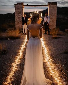 the back of a woman's dress as she walks down a path