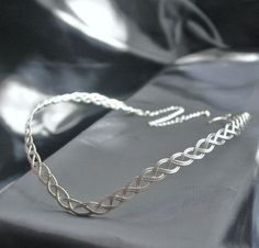 This is a handmade sterling silver plated circlet. Woven from strands of sturdy copper based sterling silver plated metal into a flattering Celtic knot headpiece. Suitable for both Men And Women. To the back is an extender chain and clasp to make this adjustable and fit any head size. Adjustable Elven Style Metal Jewelry, Silver Elven Jewelry For Festivals, Silver Elven Style Jewelry For Festivals, Adjustable Silver Elven Jewelry, Adjustable Silver Jewelry Headband, Silver Adjustable Headband For Festivals, Handmade Silver Headband, Adjustable Silver Crown Headband, Handmade Silver Headband Jewelry