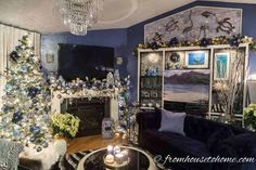 a living room decorated for christmas with blue and white decor